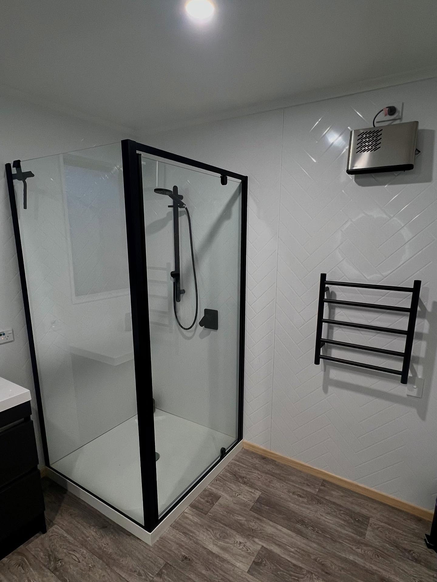 Black framed shower with modern fixtures