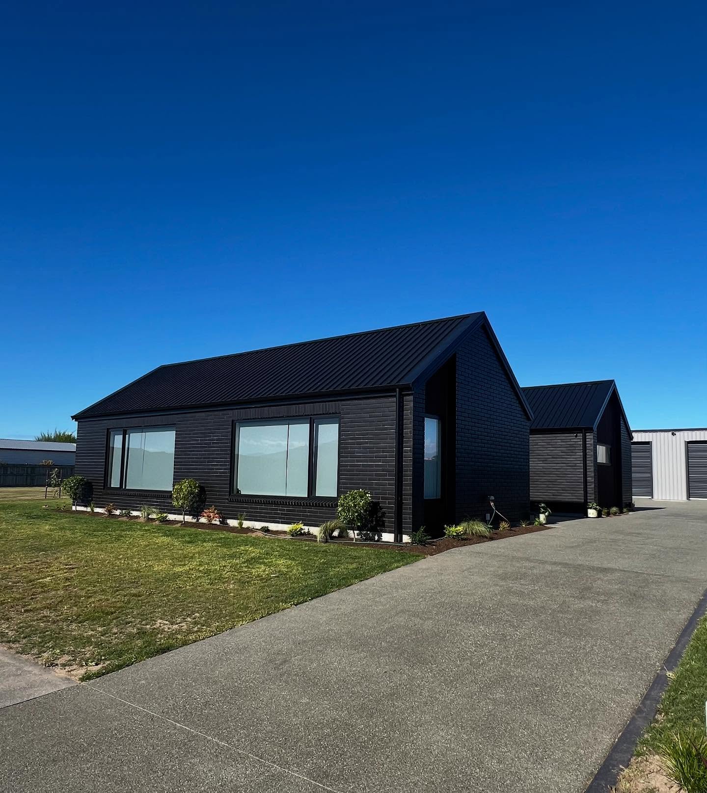 Cedar cladding and black brick detail